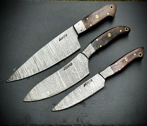 Three knives with wooden handles on a dark surface
