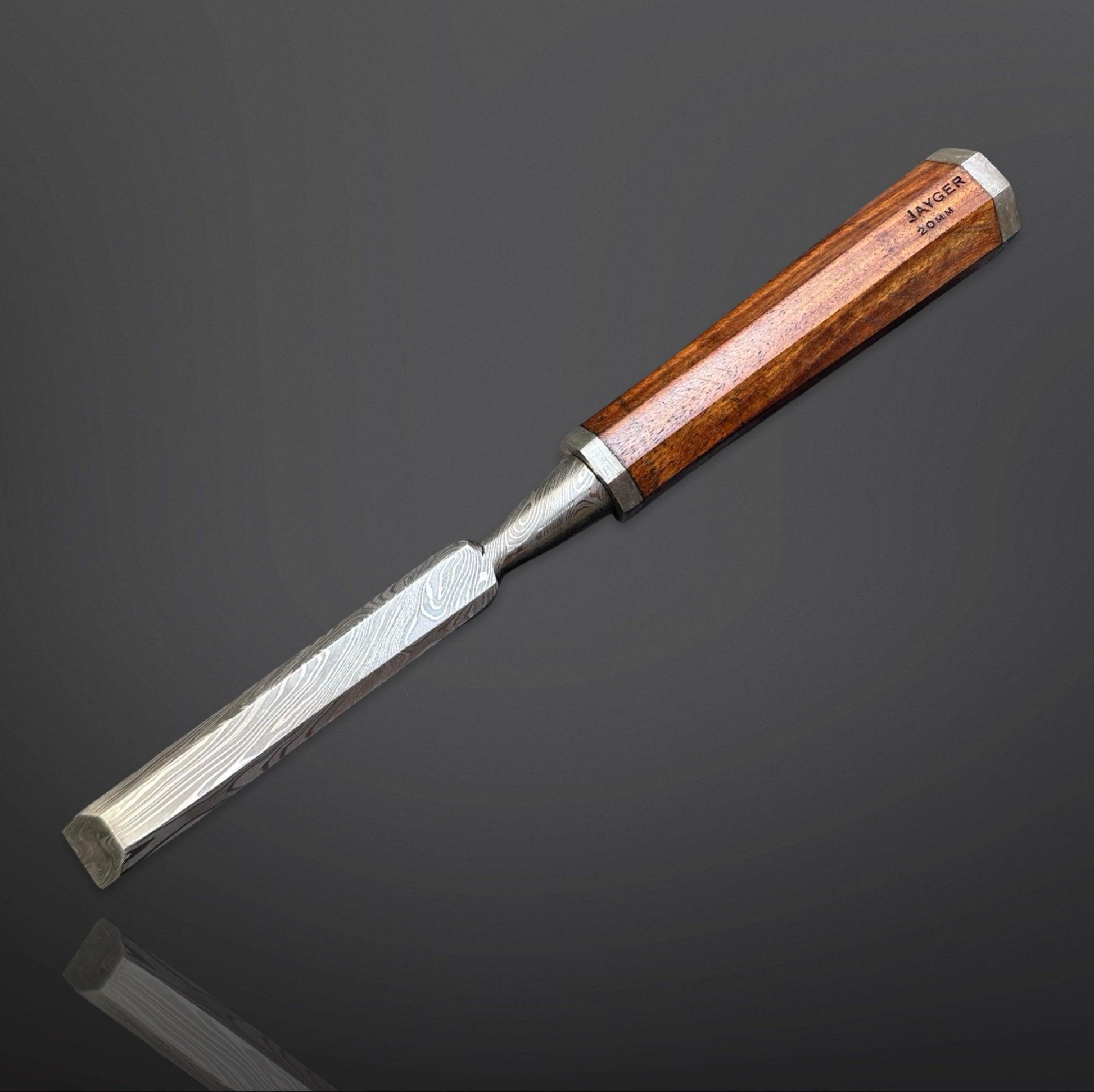 Wood chisel with wooden handle on a dark reflective surface