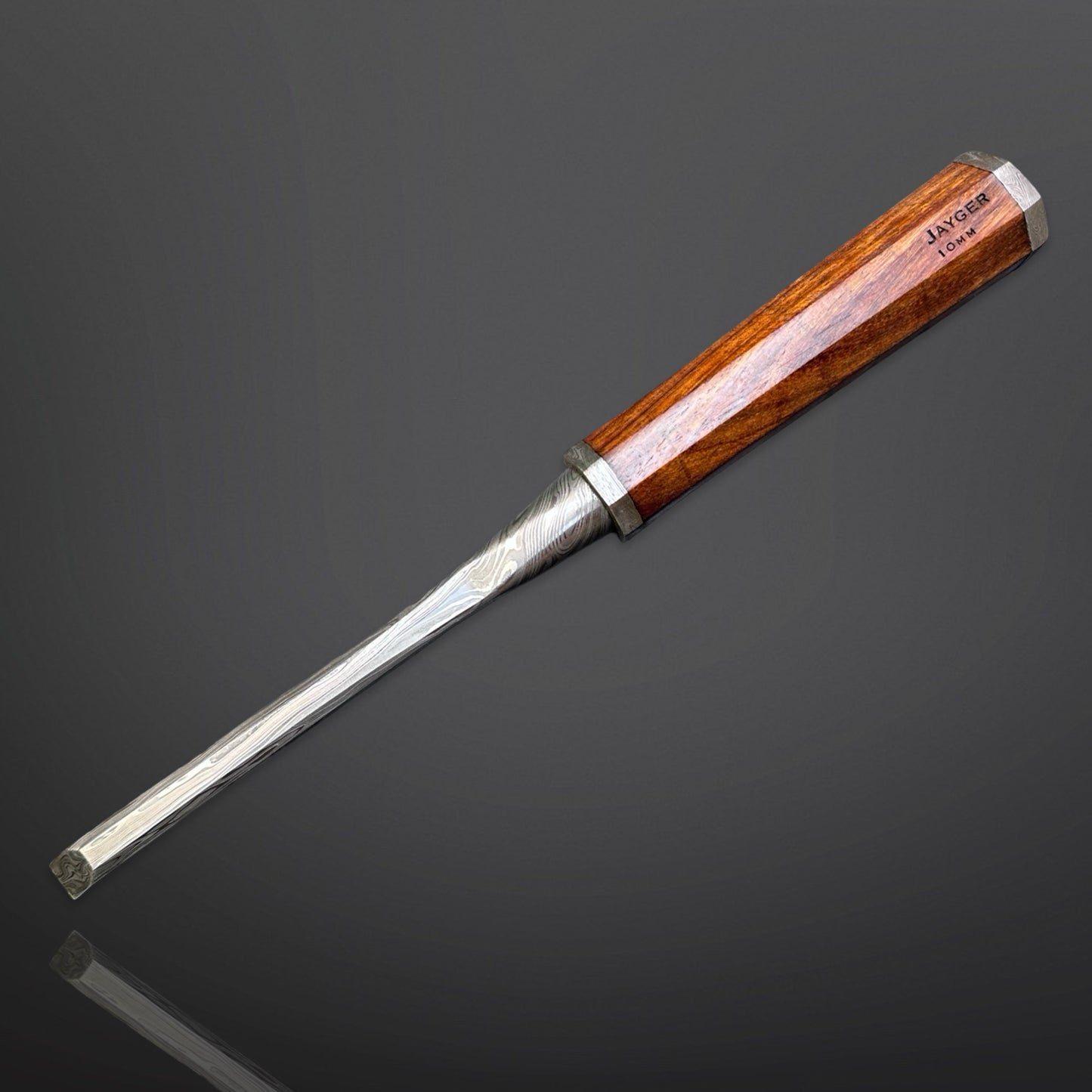 Wooden-handled chisel on a dark gray background