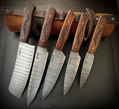 Set of five Damascus steel knives with wooden handles on a dark background